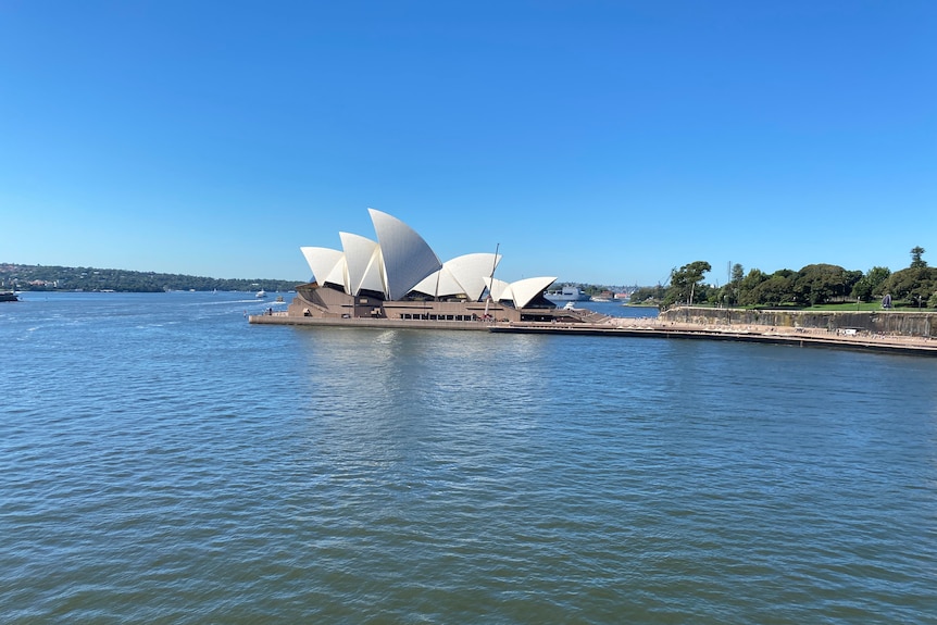 The Sydney Opera House and Sydney Harbour on a sunny day. 