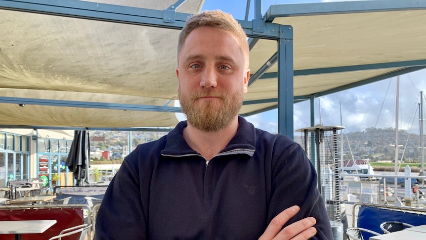 A smiling man outside a restaurant