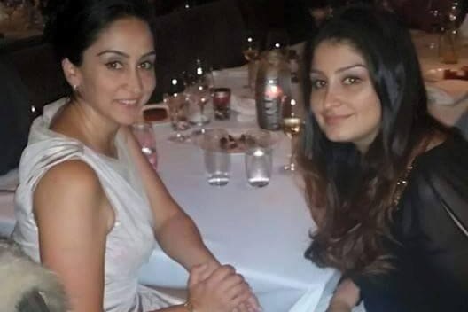 Maz Seyed sits withe her sister at a formal event
