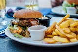 A burger and chips on a plate.