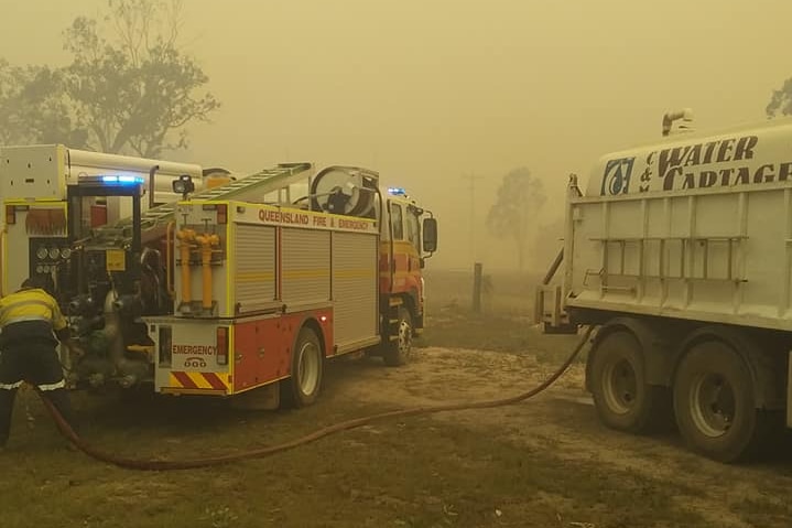 Smoke haze on the ground near Deepwater, with fire truck.