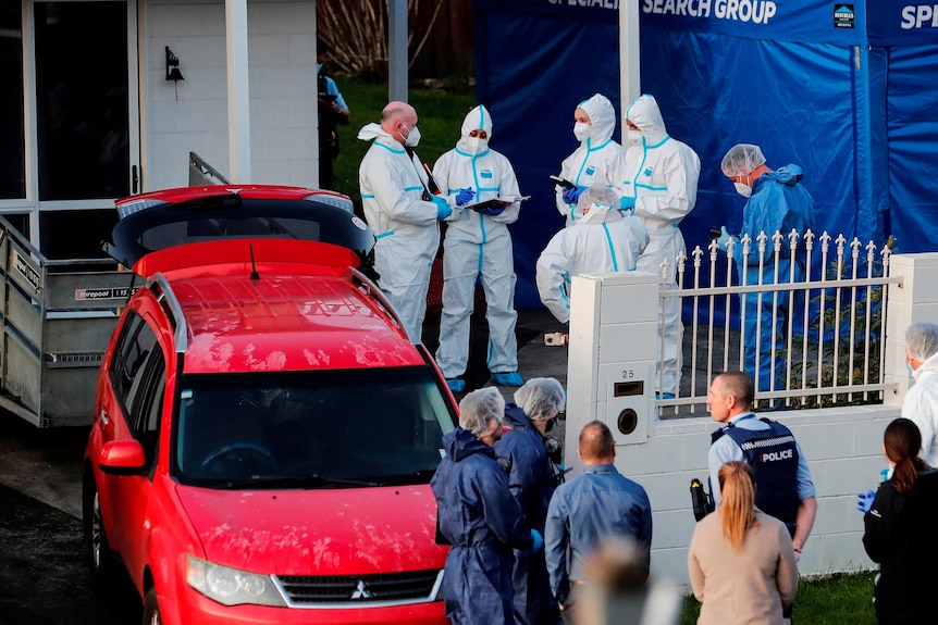 New Zealand police investigators work at a scene