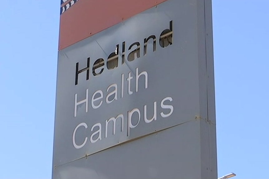a close up of a run down sign saying hedland health campus