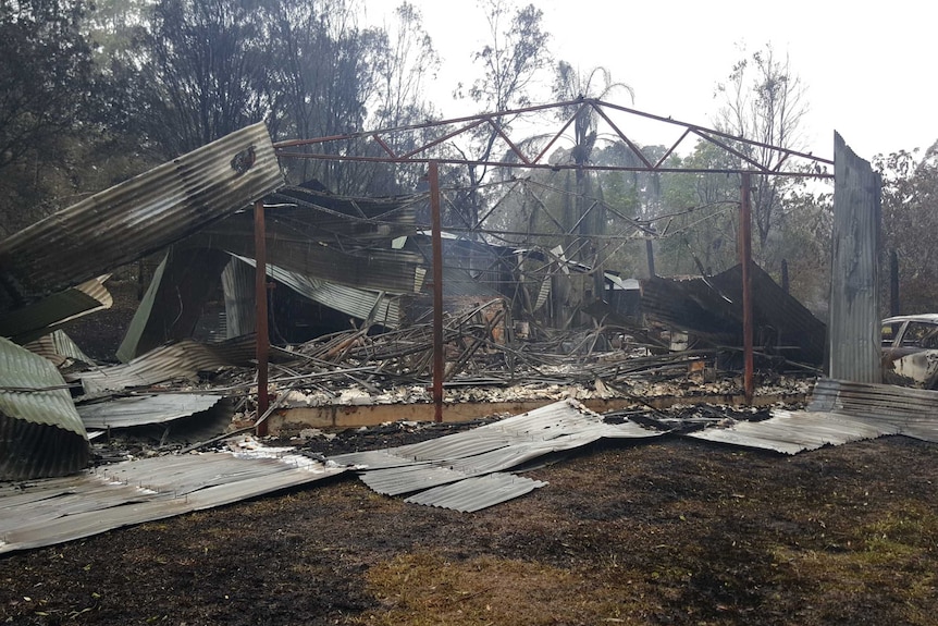 The frame of a burnt out house destroyed by bushfire
