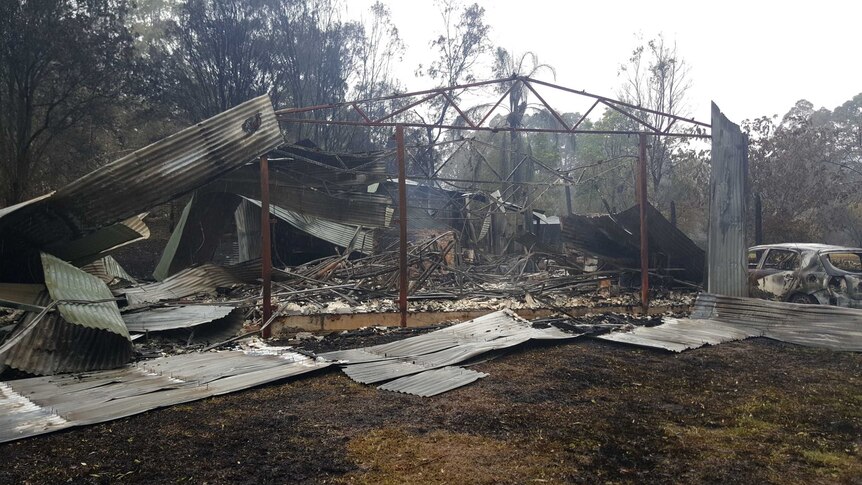 The frame of a burnt out house destroyed by bushfire