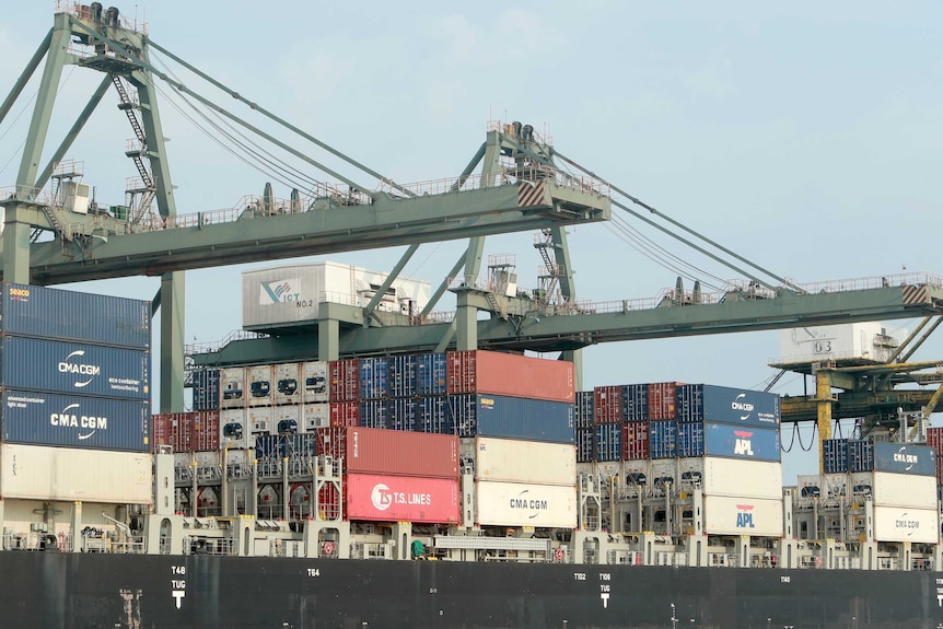 Containers are loaded on a ship at the Saigon port