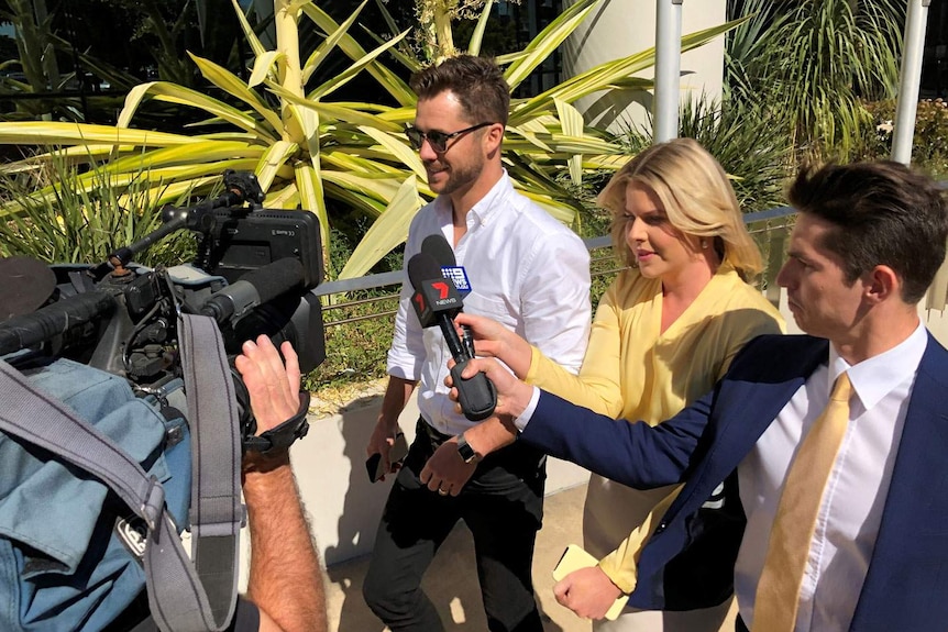 Neighbours actor Scott McGregor leaves court at Southport on Queensland's Gold Coast on August 20, 2019 with media following.