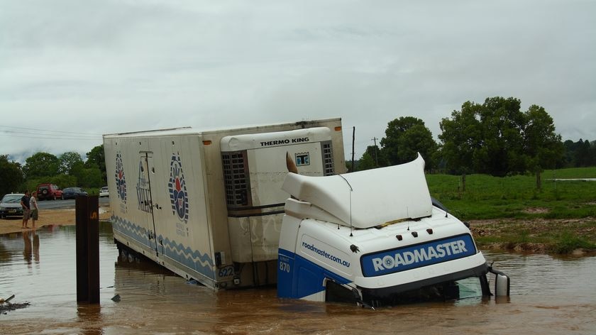 A milk truck sits half submerged in a flooded culvert near Bellingen on November 7, 2009.