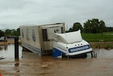 A milk truck sits half submerged in a flooded culvert near Bellingen on November 7, 2009.