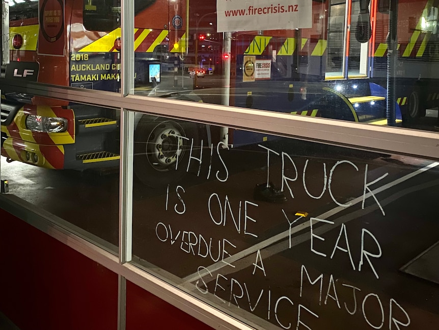 A message written on the glass outside a fire station reads "This truck is one year overdue a major service."