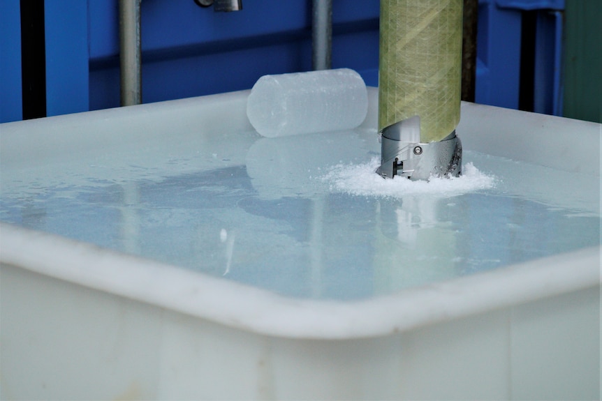 A drill being used to extract a column of ice
