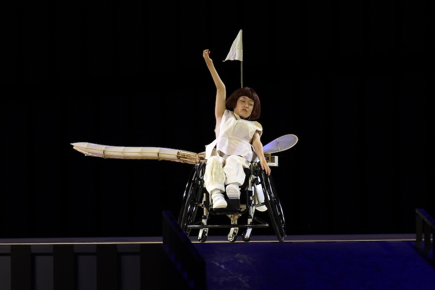 Young girl in a wheel chair performs interpretive dance. 