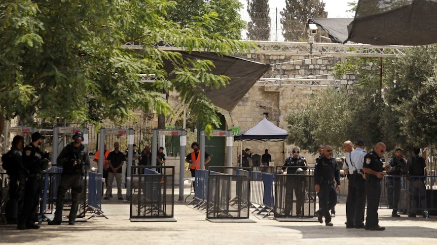 Israeli border police officers stand near newly installed cameras at the entrance to the Al Aqsa Mosque.