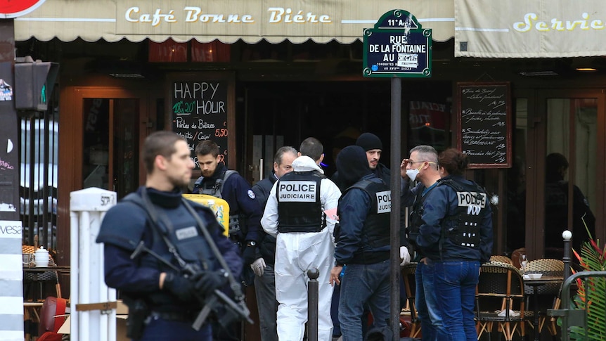 Police investigators work at the scene of the shooting in a bar.