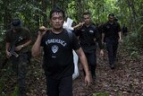 Police exhume a body from a camp in Malaysia