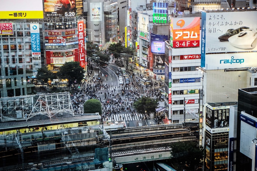 A wide shot takes in a view of the Tokyo metropolis with the busy Shibuya road crossing in the centre of the image.