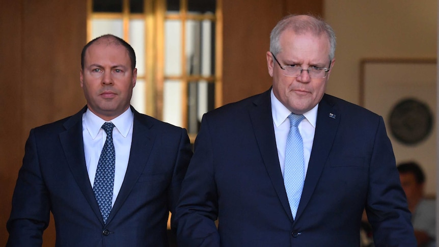 Scott Morrison and Josh Frydenberg walk from the prime minister's office into a courtyard