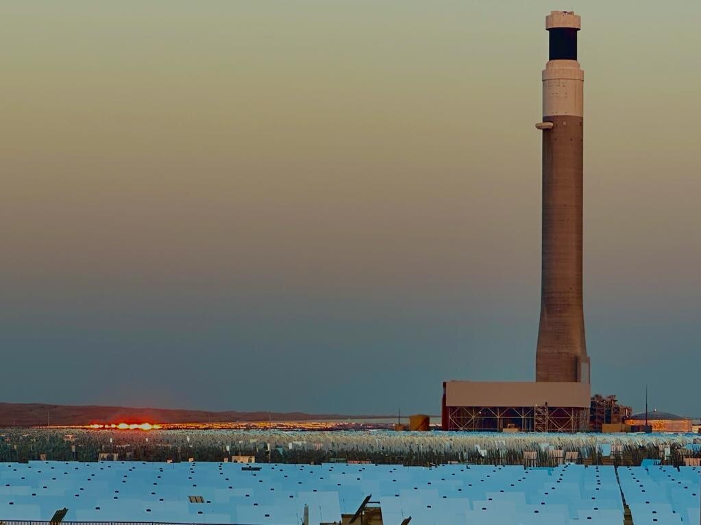 A solar thermal plant at sunset.