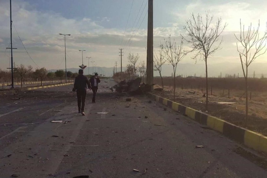 Debris is littered across a two lane road.