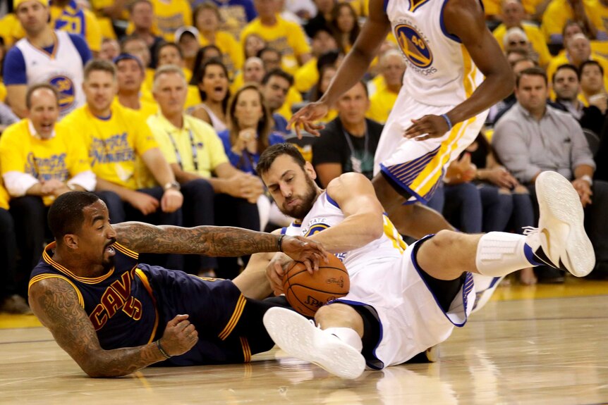 Andrew Bogut and JR Smith battle for possession in the NBA Finals
