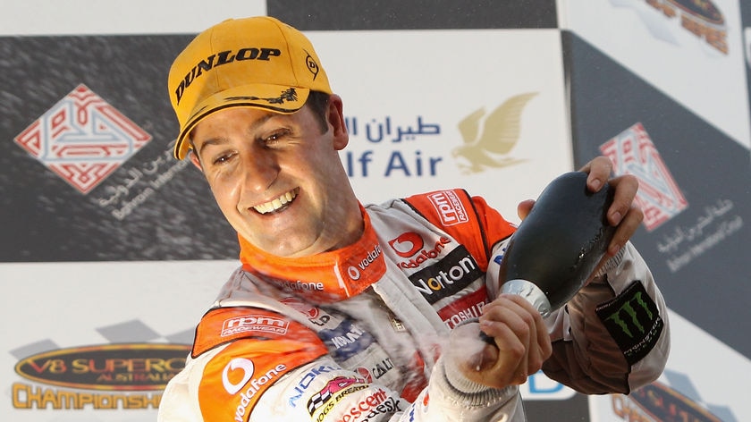 Jamie Whincup sprays champagne