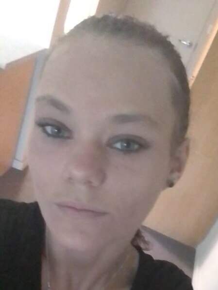 A selfie of Teisha Keley, who wears a dark shirt with her hair pulled back