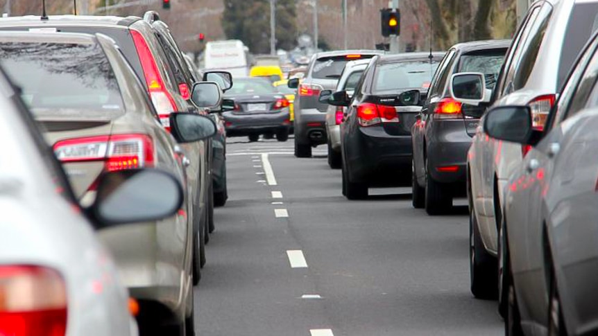 Cars stopped close to one another in peak hour traffic