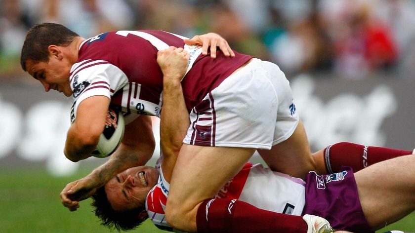 Manly's Anthony Watmough falls onto Melbourne's Cooper Cronk