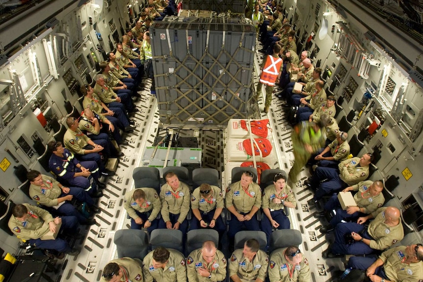 Rescuers onboard a plane.