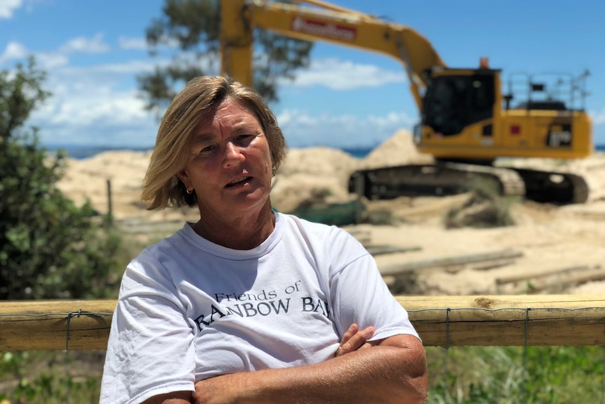 Friends of Rainbow Bay Society spokeswoman Kate Miller standing in front of machinery