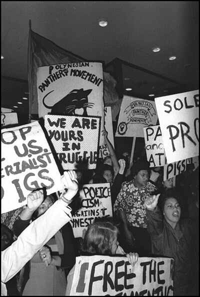 A shot of a group of protest signs and young people. 