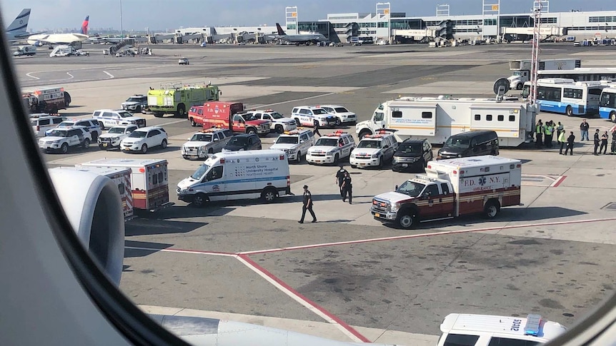 Ambulances can be seen through a plane window.