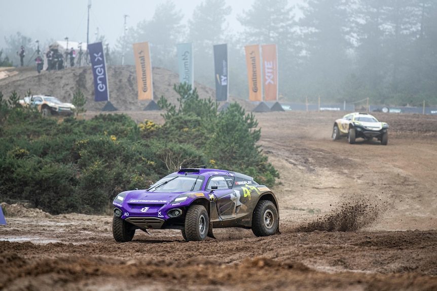 Electronic cars race around a muddy track
