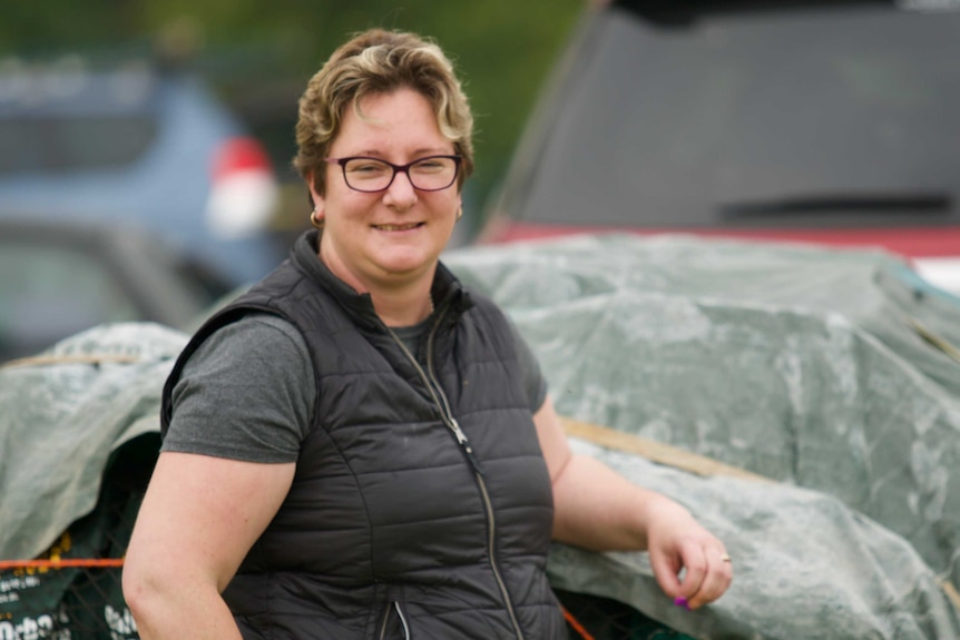 Chrystal Hall leans with her elbow up on a trailer.