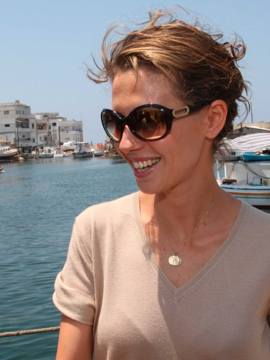 The wife of Syrian dictator Bashar al-Assad smiles in the sun