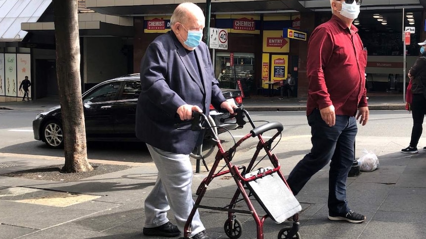 Two men wearing masks