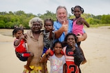 an aboriginal woman, kids and a man smiling with thumbs up