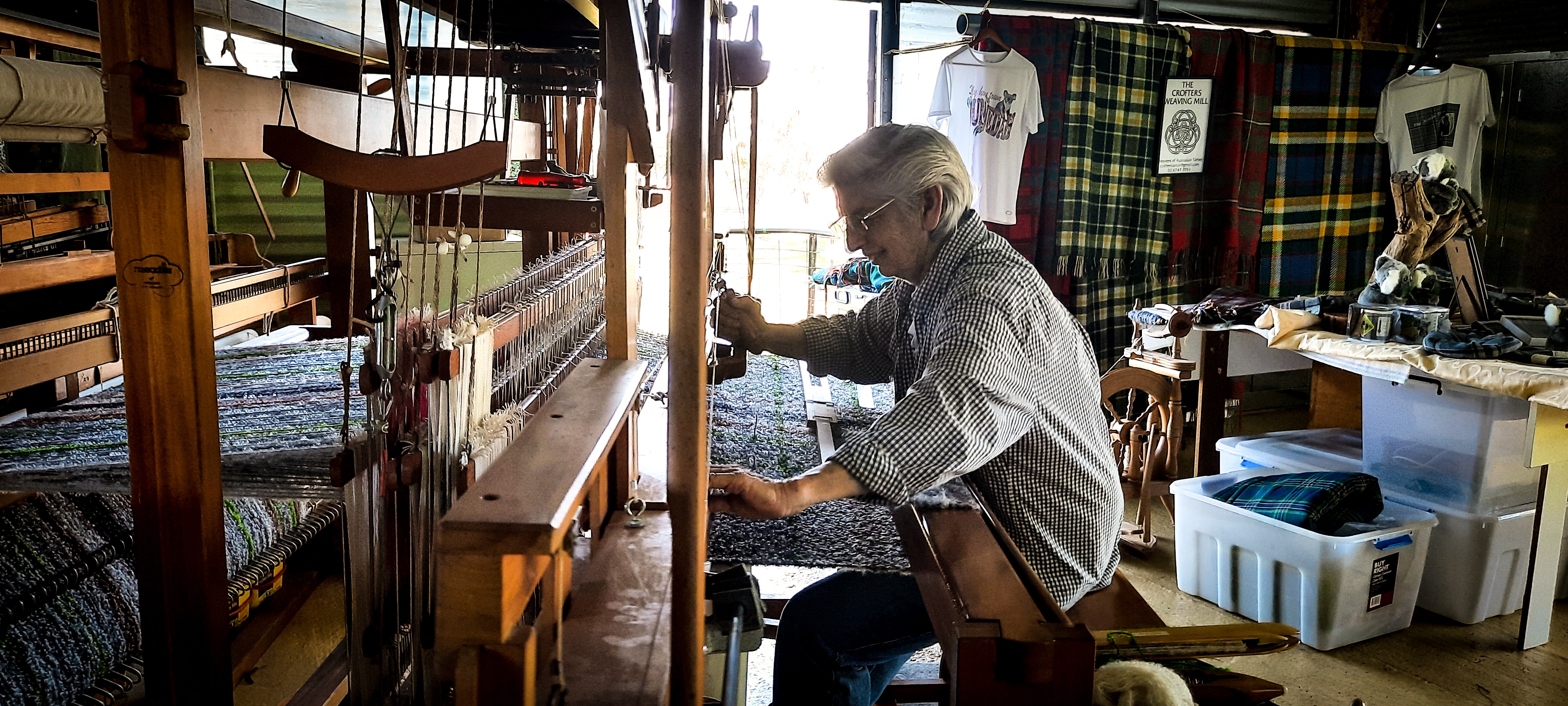 woman at loom with light behind her