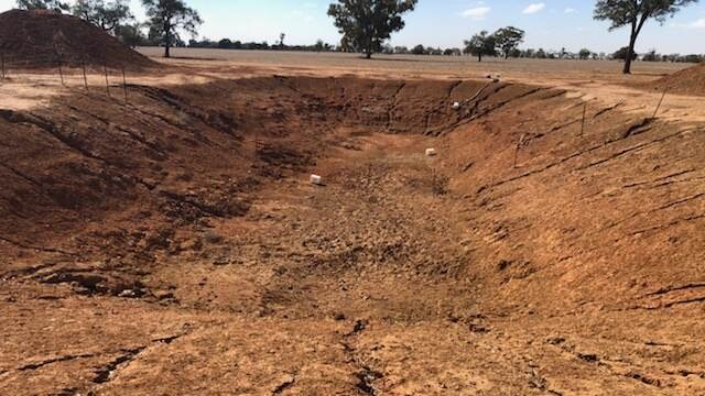 A large, empty, dry dam.