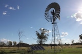 A windmill on Undoolya station with a new solar panel beside it