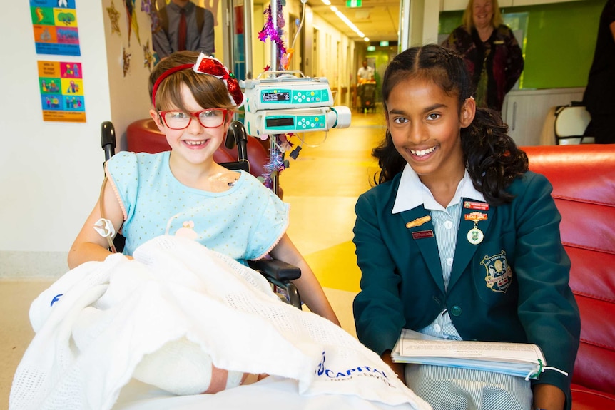 Reshmi Senanayake with Rosie Roarty in the children's ward of Canberra children's hospital