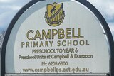 A primary school with a noticeboard out front that reads "Campbell Primary School".
