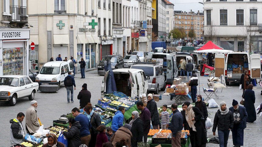 People shop at a market in the neighbourhood of Molenbeek