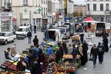 People shop at a market in the neighbourhood of Molenbeek