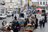 People shop at a market in the neighbourhood of Molenbeek