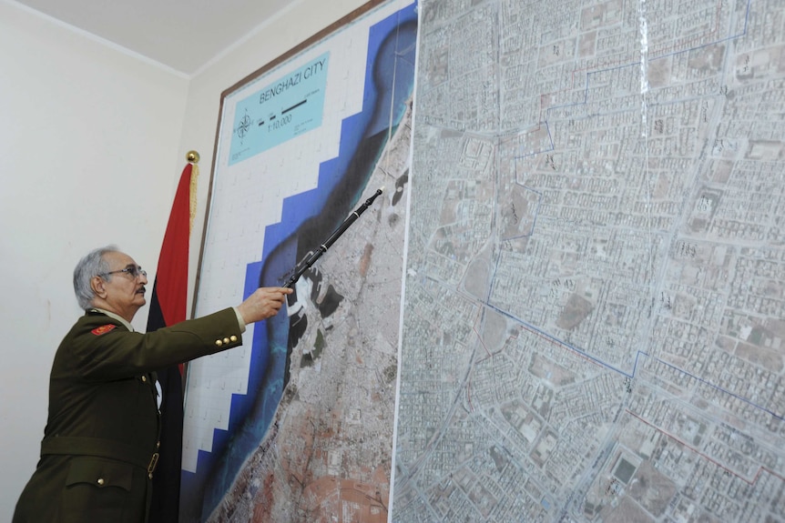In 2015 General Khalifa Hafter, Libya's top army chief, points at a map in his office.