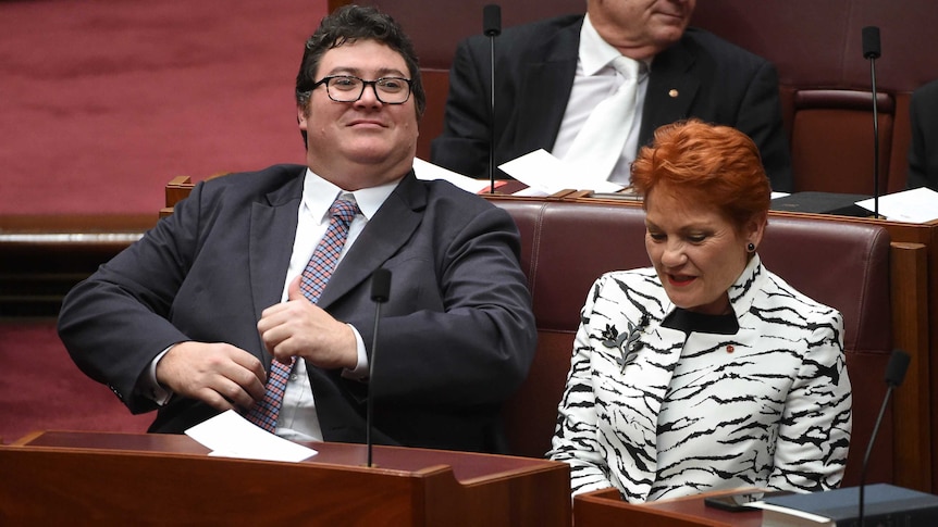 George Christensen stares away from the camera as he sits next to Pauline Hanson