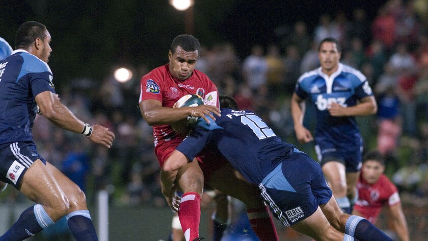 Reds skipper Will Genia is upended at Ballymore.