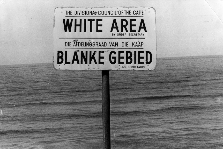 A black and white photo of a sign reading: 'White Area', with the same text in Afrikaans.
