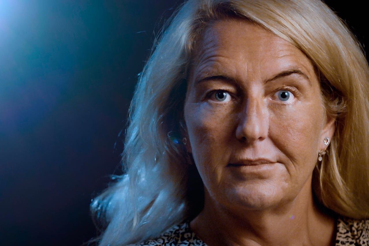 Nicola Gobbo, a woman with blonde hair and blue eyes, looks at the camera.